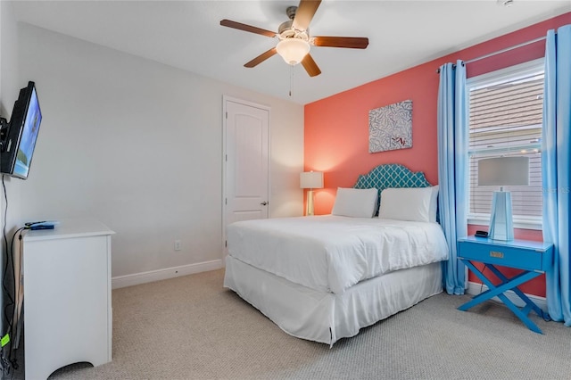 bedroom featuring light carpet and ceiling fan