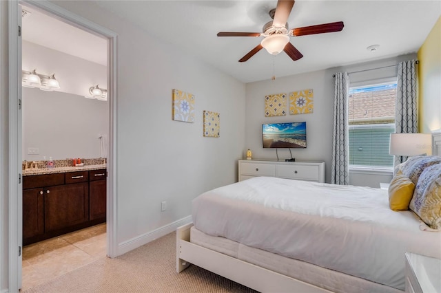 carpeted bedroom with ceiling fan and ensuite bath