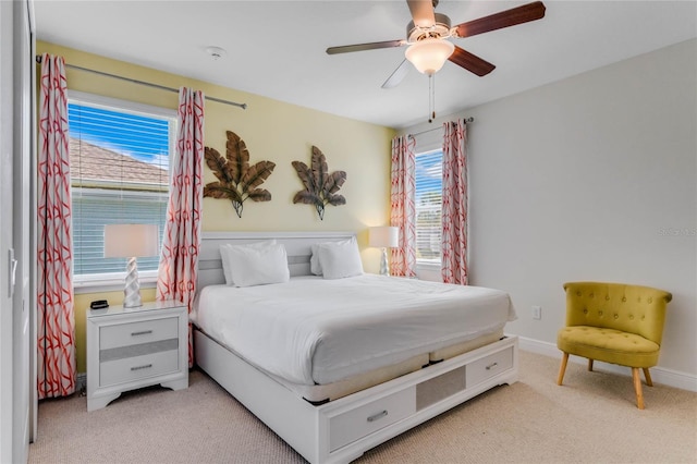 bedroom featuring light carpet and ceiling fan