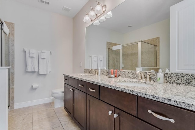 bathroom with vanity, tile patterned floors, toilet, and walk in shower