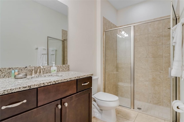 bathroom featuring an enclosed shower, vanity, tile patterned floors, and toilet