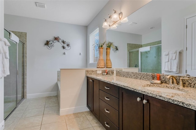 bathroom with tile patterned flooring, vanity, and an enclosed shower