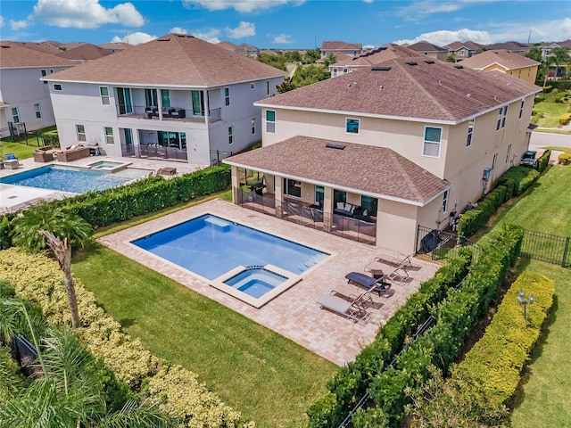 view of swimming pool with a bar, a yard, a patio area, and an in ground hot tub