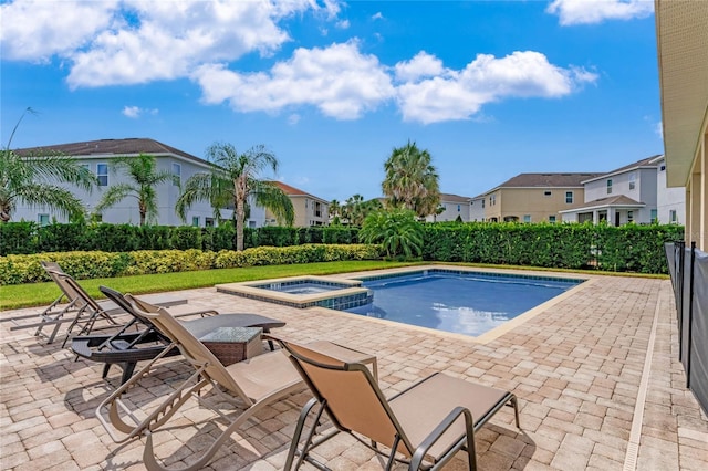 view of swimming pool featuring an in ground hot tub and a patio