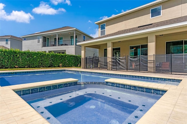 view of swimming pool featuring an in ground hot tub