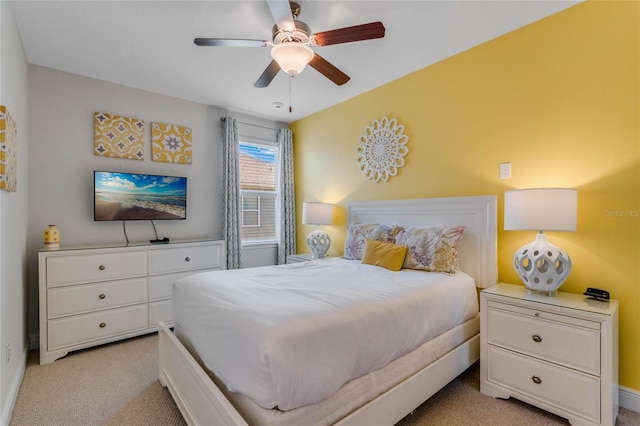 bedroom featuring light carpet and ceiling fan