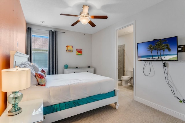 bedroom with ceiling fan, connected bathroom, and light carpet