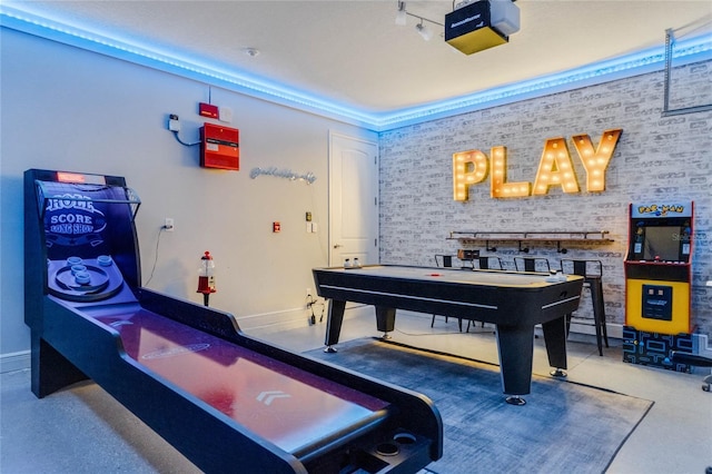 game room featuring brick wall