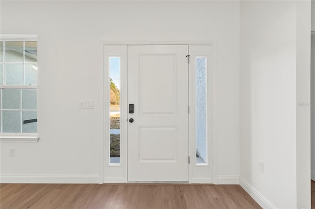 foyer entrance with light hardwood / wood-style flooring