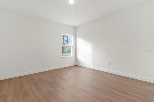 empty room with light hardwood / wood-style floors