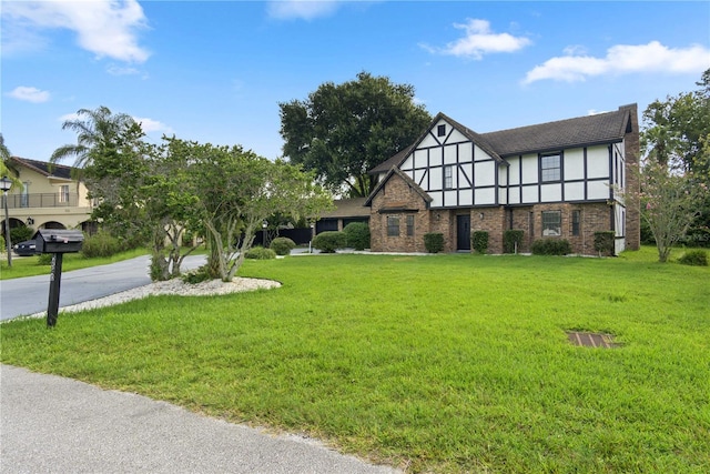 tudor-style house with a front lawn