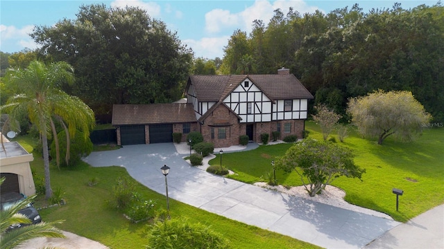 view of front of property with a garage and a front lawn