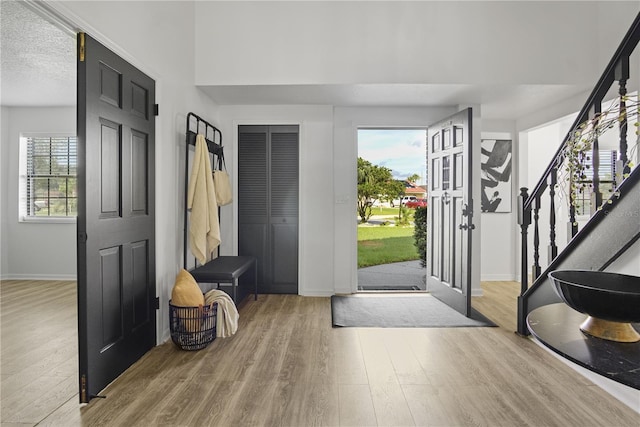 foyer entrance featuring hardwood / wood-style floors and a textured ceiling