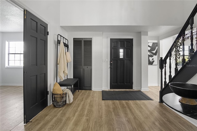 entryway featuring a textured ceiling and light wood-type flooring