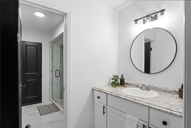 bathroom with vanity and a shower with shower door