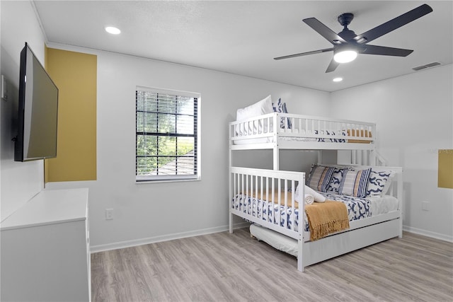 bedroom with light hardwood / wood-style flooring and ceiling fan