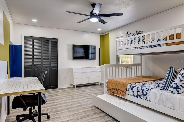 bedroom featuring a closet, ceiling fan, and light hardwood / wood-style floors