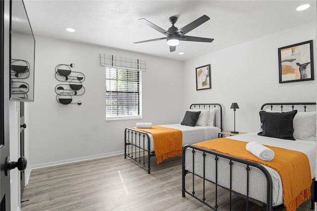 bedroom with light wood-type flooring and ceiling fan