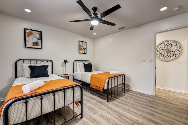 bedroom featuring light wood-type flooring and ceiling fan