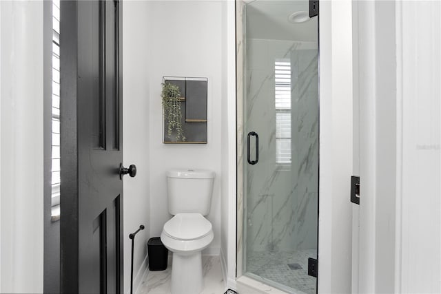 bathroom featuring toilet and an enclosed shower