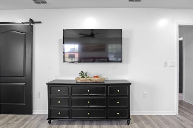 details featuring hardwood / wood-style flooring and a barn door