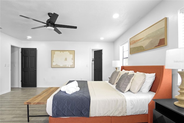 bedroom with ceiling fan and hardwood / wood-style floors