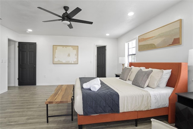 bedroom featuring ceiling fan and hardwood / wood-style flooring