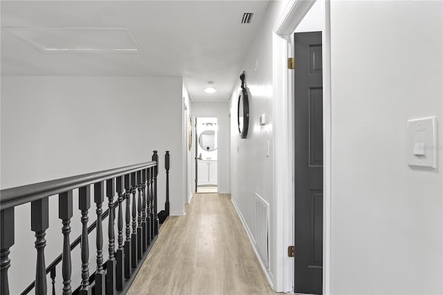 corridor with light hardwood / wood-style floors