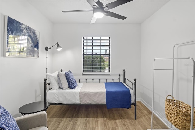 bedroom with ceiling fan and hardwood / wood-style floors