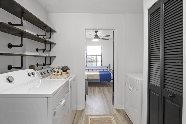 laundry room featuring ceiling fan, light hardwood / wood-style flooring, and washer and dryer