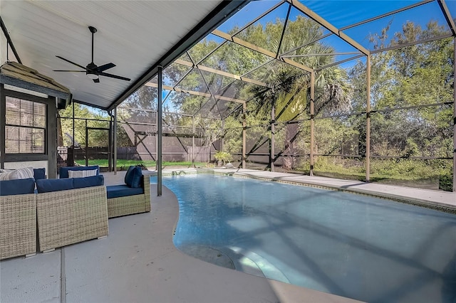 view of pool with ceiling fan, glass enclosure, an outdoor hangout area, and a patio area