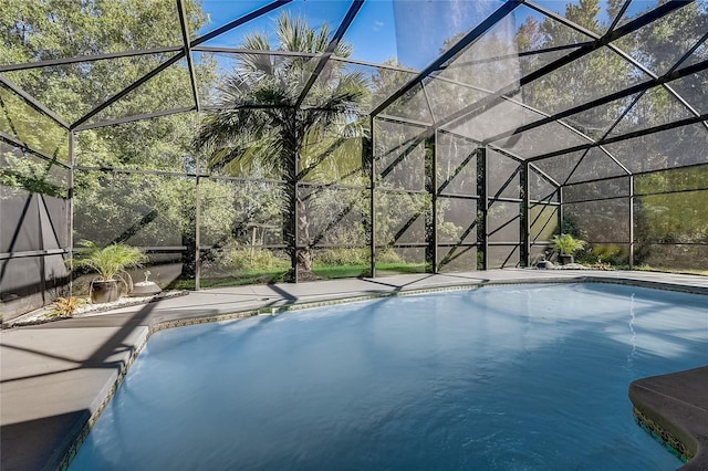 view of swimming pool with glass enclosure and a patio area