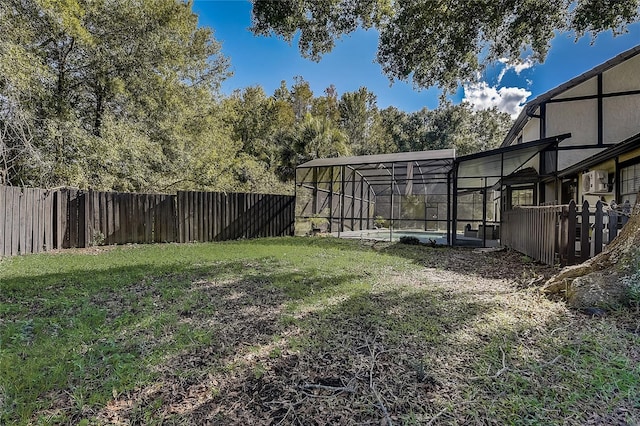 view of yard with a fenced in pool and a lanai