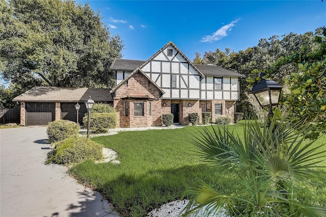 tudor-style house with a front yard and a garage