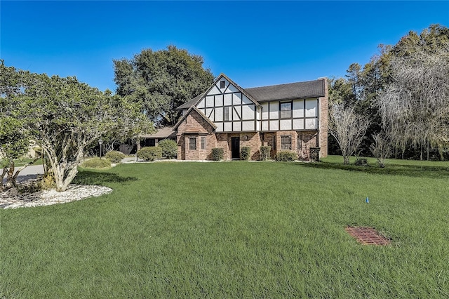 tudor-style house with a front lawn