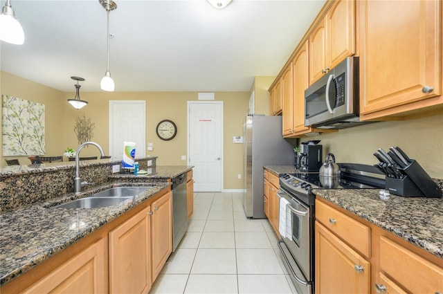 5012 Shoreway Loop Unit 10207, Orlando, FL 32819 - kitchen with appliances with stainless steel finishes, light tile patterned floors, dark stone counters, and pendant lighting