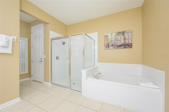 5012 Shoreway Loop Unit 10207, Orlando, FL 32819 - full bath featuring a bath, a stall shower, and tile patterned floors