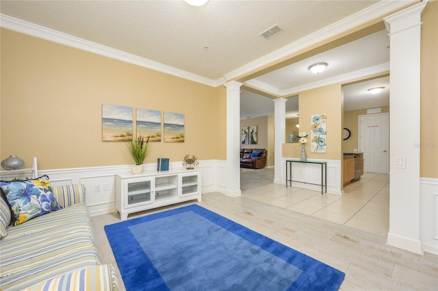 5012 Shoreway Loop Unit 10207, Orlando, FL 32819 - living room featuring decorative columns, ornamental molding, wainscoting, and light wood-style floors