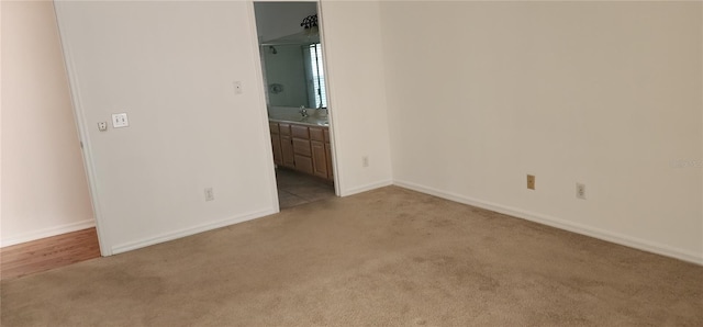 carpeted empty room featuring sink