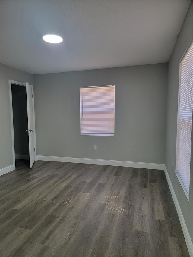 empty room with dark wood-type flooring