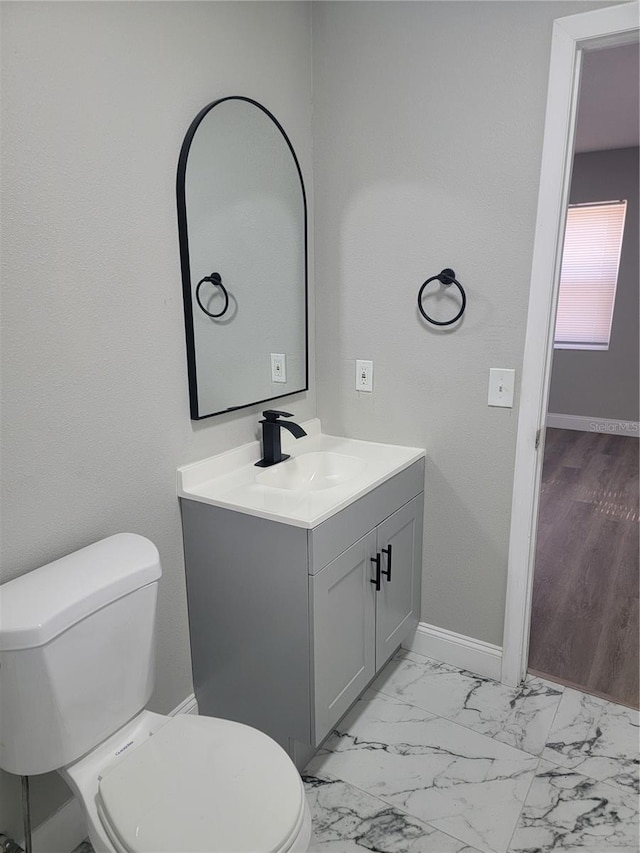 bathroom featuring vanity and toilet