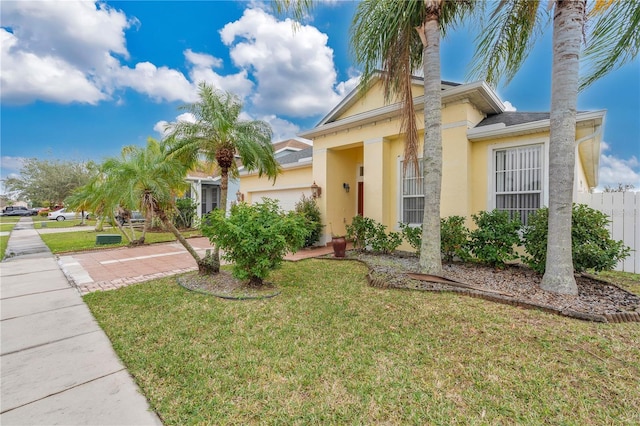 view of front of property featuring a garage and a front lawn