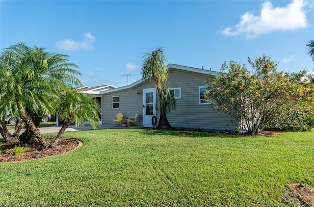 back of house with a lawn