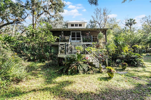 rear view of house featuring a sunroom