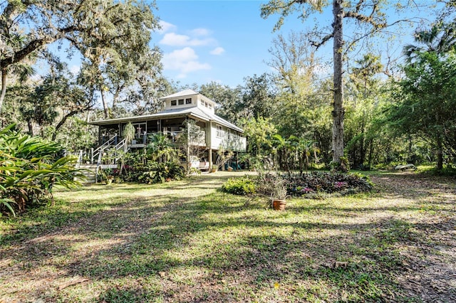 view of yard with a sunroom