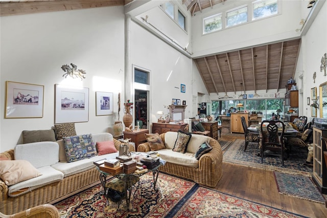 living room featuring beamed ceiling, wood-type flooring, wood ceiling, and high vaulted ceiling