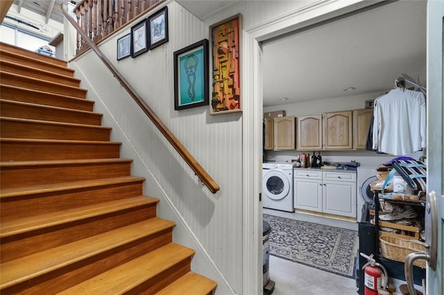 laundry area with washer / dryer, wooden walls, and cabinets