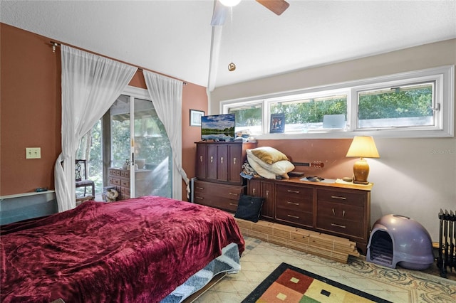 bedroom with multiple windows, access to outside, ceiling fan, and vaulted ceiling