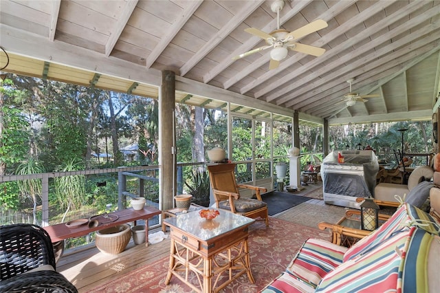 sunroom featuring vaulted ceiling with beams and ceiling fan