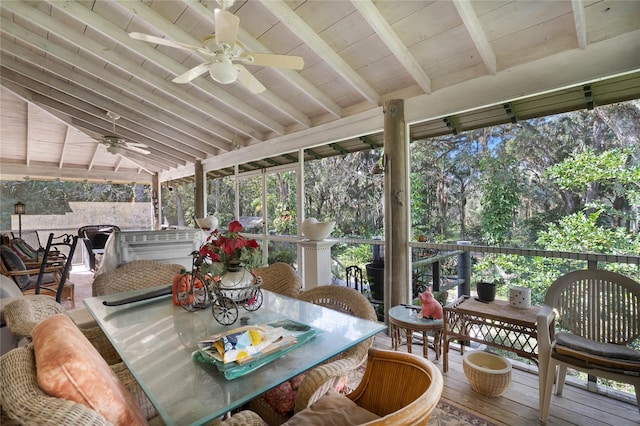 sunroom / solarium with ceiling fan, wooden ceiling, and vaulted ceiling with beams